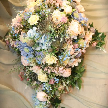 Small peach and wildflower casket spray