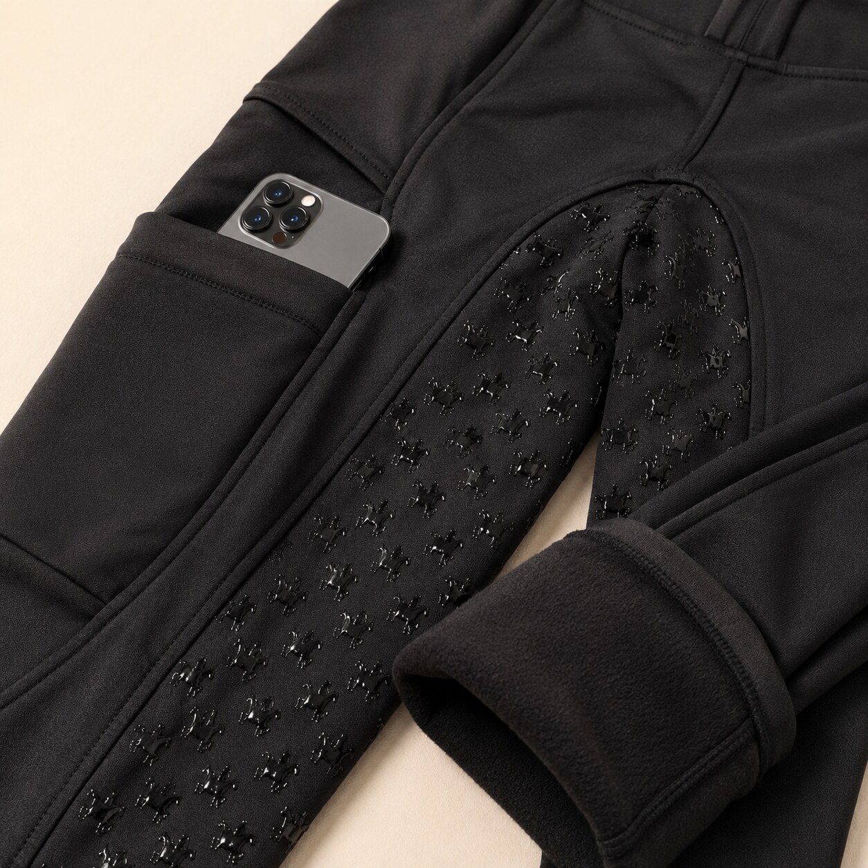 Close up: V29 winter riding leggings showing fold-over phone pocket, pony silicone grip and fleece lining.