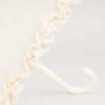 Elegant ivory wedding umbrella with ruffled edge and curved handle.