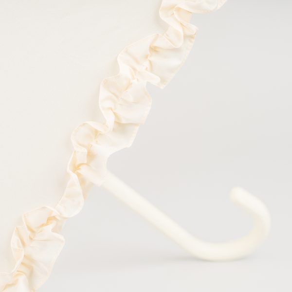 Elegant ivory wedding umbrella with ruffled edge and curved handle.