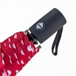 Red and white polka dot umbrella with automatic open/close button.