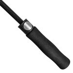 Close-up of a golf umbrella handle with ergonomic grip and wind-resistant features.
