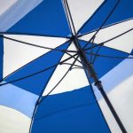 Blue and white wind-resistant golf umbrella with sturdy frame.