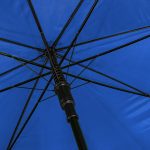 Close-up of a blue wind-resistant golf umbrella with black ribs and shaft.