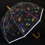 Clear children's umbrella with colourful digger and dump truck pattern.