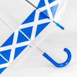 Clear umbrella with blue and white geometric design and blue handle.