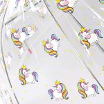 Clear umbrella with colourful unicorn and star pattern for children.
